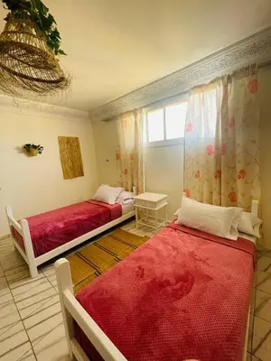 a bedroom with two beds and a window at Coquet Appartement Casablanca in Casablanca