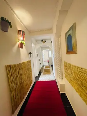 a hallway with a red carpet and some stairs at Coquet Appartement Casablanca in Casablanca