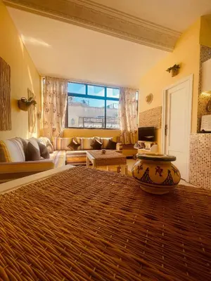 a living room with a large bed and a couch at Charming Studio In Casablanca in Casablanca