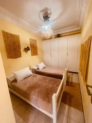 two beds in a room with a ceiling at Charming Studio In Casablanca in Casablanca