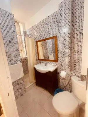 a bathroom with a sink and a toilet and a mirror at Charming Studio In Casablanca in Casablanca