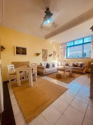 a living room with a table and a couch at Charming Studio In Casablanca in Casablanca