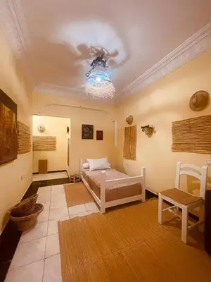 a living room with a bed and a ceiling at Charming Studio In Casablanca in Casablanca
