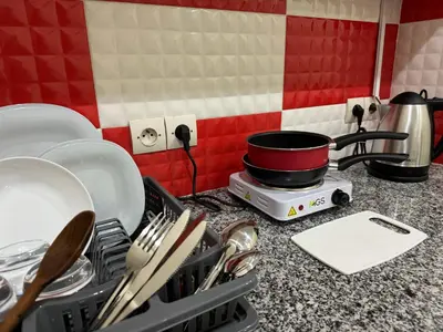 a kitchen counter with dishes in a dish drying rack at Casablanca Central Suites - Casa Port in Casablanca