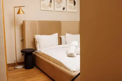 a bedroom with a bed with white sheets and pillows at Central Charm: 1-Bed Apartment in Hay Riad in Rabat