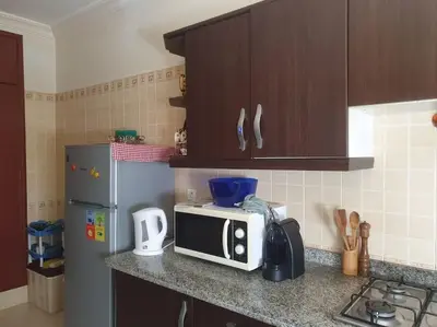 a kitchen counter with a microwave and a refrigerator at Appartement spacieux, exceptionnel in Temara