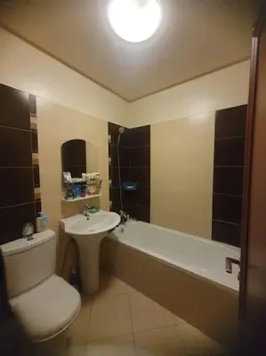 a bathroom with a toilet and a sink and a tub at Appartement spacieux, exceptionnel in Temara