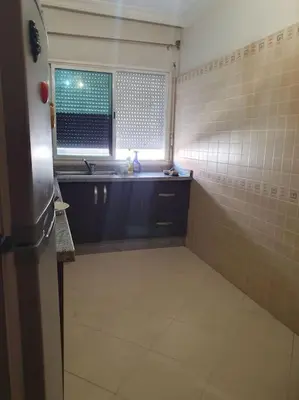 a small bathroom with a sink and a window at Appartement spacieux, exceptionnel in Temara