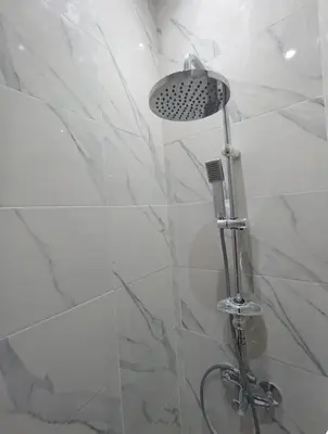 a shower with a shower head in a bathroom at Lovely Studio in the city centre with WIFI. in Casablanca