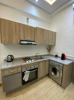a kitchen with a sink and a washing machine at Lovely Studio in the city centre with WIFI. in Casablanca