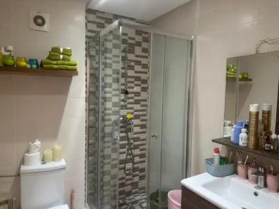 a bathroom with a shower and a toilet and a sink at Belle appartement tout neuf in Bouznika
