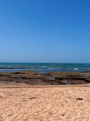 a sandy beach with the ocean in the background at Cozy 2 bedrooms flat at Dar Bouazza in Dar Bouazza