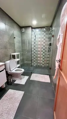 a bathroom with a shower and a toilet at Cozy 2 bedrooms flat at Dar Bouazza in Dar Bouazza