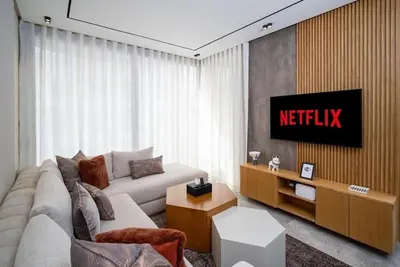 a living room with a couch and a television at Studio chic avec parking in Casablanca
