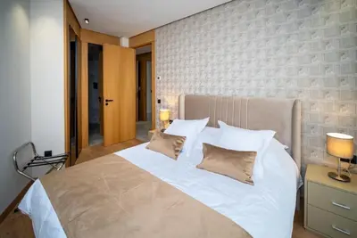 a bedroom with a large white bed with pillows at Studio chic avec parking in Casablanca