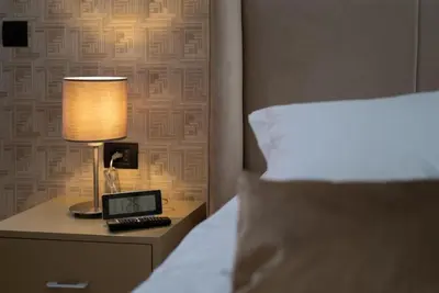 a bed with a lamp and a laptop on a night stand at Studio chic avec parking in Casablanca
