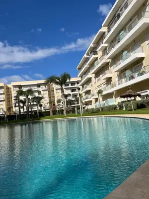 a swimming pool in front of a building at Bouznika Beach appartement de luxe avec piscine in Bouznika