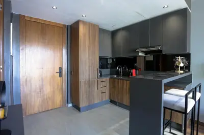 a kitchen with wooden cabinets and a counter top at Résidence Galilée - Gauthier in Casablanca