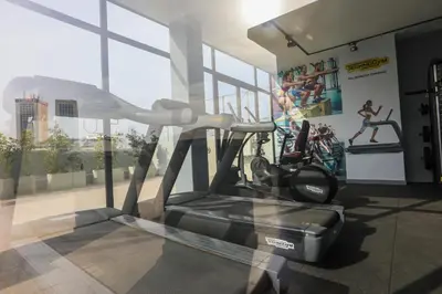 a gym with a treadmill in a room with windows at Résidence Galilée - Gauthier in Casablanca