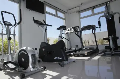 a gym with several treadmills and elliptical machines at Casablanca Suites & Spa in Casablanca