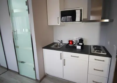 a small kitchen with a sink and a microwave at Casablanca Suites & Spa in Casablanca