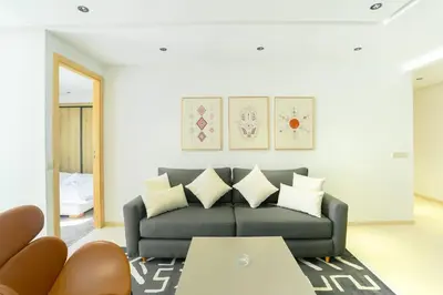 a living room with a couch and a mirror at Serenity in Casablanca