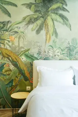 a bedroom with a wall mural of palm trees at Serenity in Casablanca