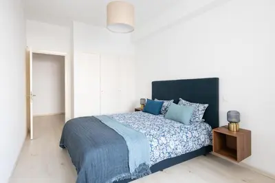 a bedroom with a large bed with blue pillows at Charming apartment, in heart of Agdal, 2 rooms in Rabat