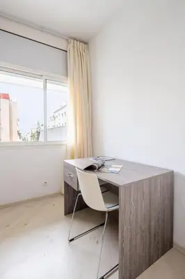 a desk with a chair in a room with a window at Charming apartment, in heart of Agdal, 2 rooms in Rabat