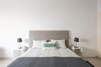 a bedroom with a large bed with two lamps at Charming apartment, in heart of Agdal, 2 rooms in Rabat