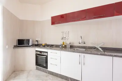 a kitchen with white cabinets and a microwave at Charming apartment, in heart of Agdal, 2 rooms in Rabat