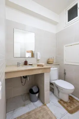 a bathroom with a toilet and a sink and a mirror at Charming apartment, in heart of Agdal, 2 rooms in Rabat