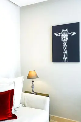 a bedroom with a giraffe picture on the wall at Waterloo in Casablanca