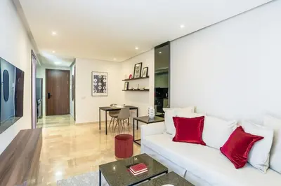 a living room with a white couch and red pillows at Waterloo in Casablanca
