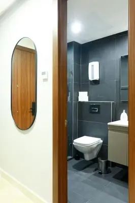 a bathroom with a sink and a toilet and a mirror at Waterloo in Casablanca