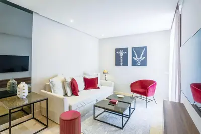 a living room with a white couch and red chairs at Waterloo in Casablanca