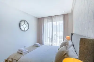 a bedroom with a large bed and a large window at Waterloo in Casablanca