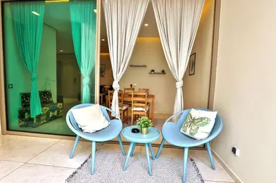 two chairs and a table in a living room at Anfa Flores in Casablanca