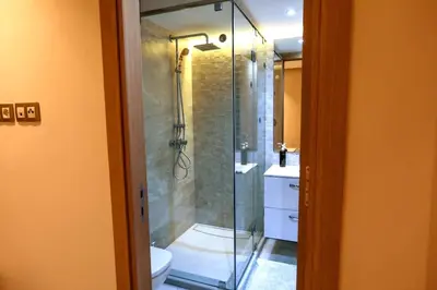 a bathroom with a glass shower and a toilet at Anfa Flores in Casablanca