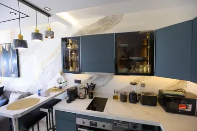 a kitchen with blue cabinets and a counter top at Modern Cozy Ghandi District in Casablanca