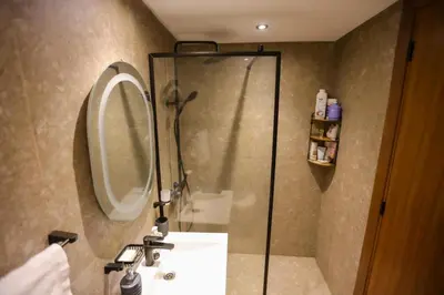 a bathroom with a shower and a sink and a mirror at Modern Cozy Ghandi District in Casablanca
