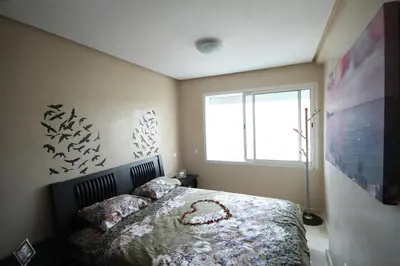 a bedroom with a bed and a window at Appartement Panoramique in Casablanca