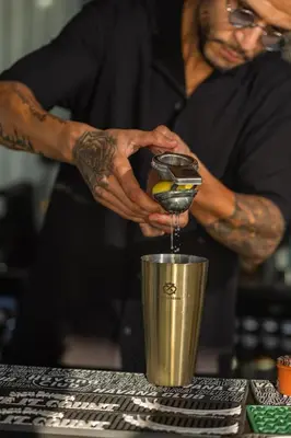 a man is making a drink in a blender at Courtyard by Marriott Casablanca Downtown in Casablanca