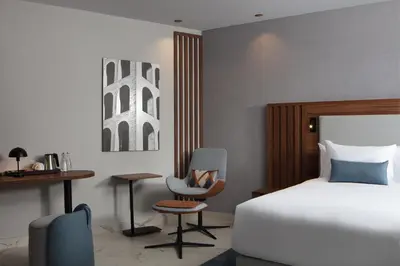 a bedroom with a bed and a chair and a desk at Courtyard by Marriott Casablanca Downtown in Casablanca