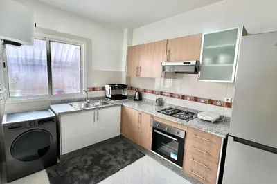 a kitchen with a sink and a dishwasher at T6 Appartement entièrement neuf au cœur de Témara in Temara