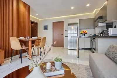 a living room and kitchen with a table and chairs at Chic and Cozy 1 Bedroom Oasis in the Heart of Casa in Casablanca