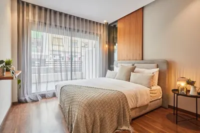 a bedroom with a bed and a large window at Chic and Cozy 1 Bedroom Oasis in the Heart of Casa in Casablanca