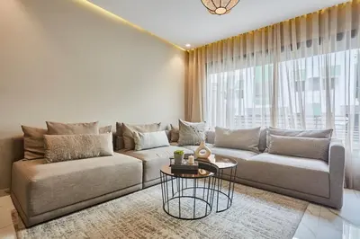 a living room with a couch and a table at Chic and Cozy 1 Bedroom Oasis in the Heart of Casa in Casablanca