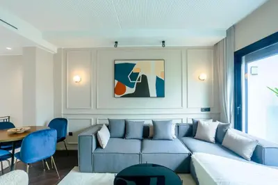 a living room with a blue couch and a table at Résidence Jade in Casablanca