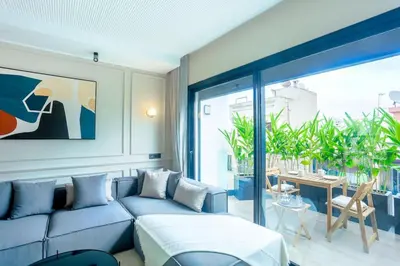 a living room with a blue couch and a table at Résidence Jade in Casablanca